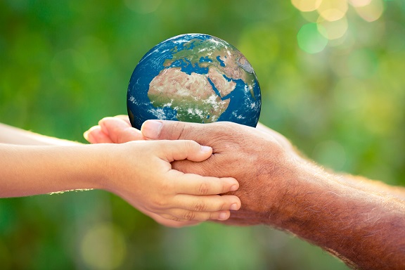 Photo of shared hands holding a globe